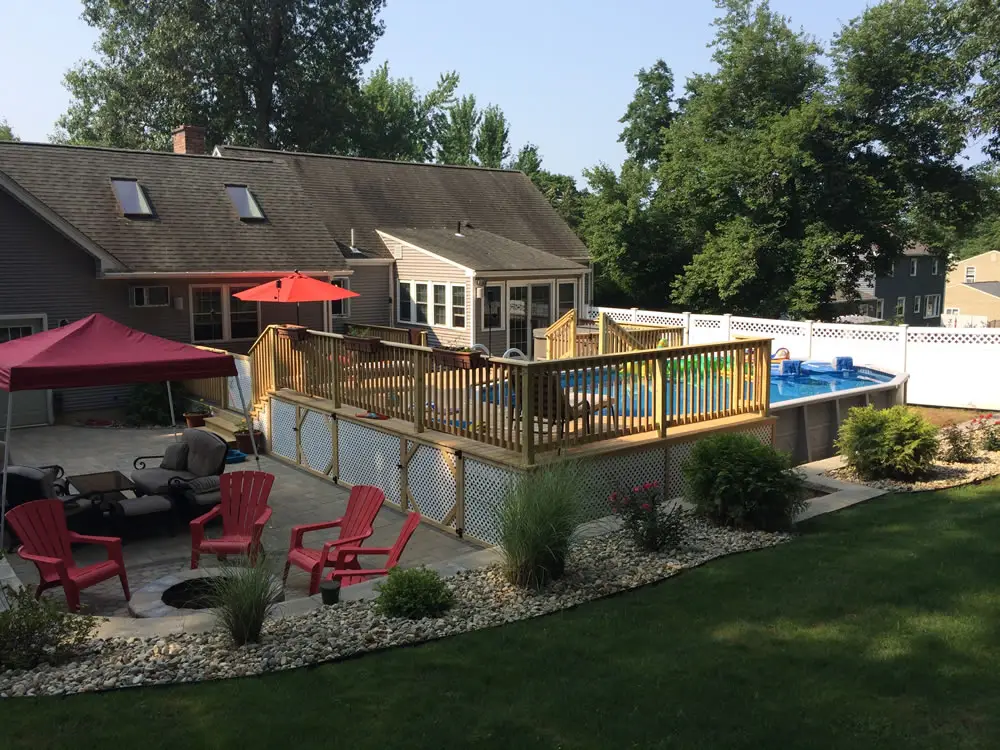 A pool deck design, pressure treated wood, custom railing and storage area