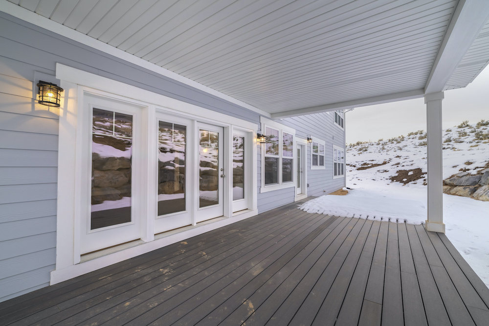Beautiful composite deck with some snow on it in the winter time