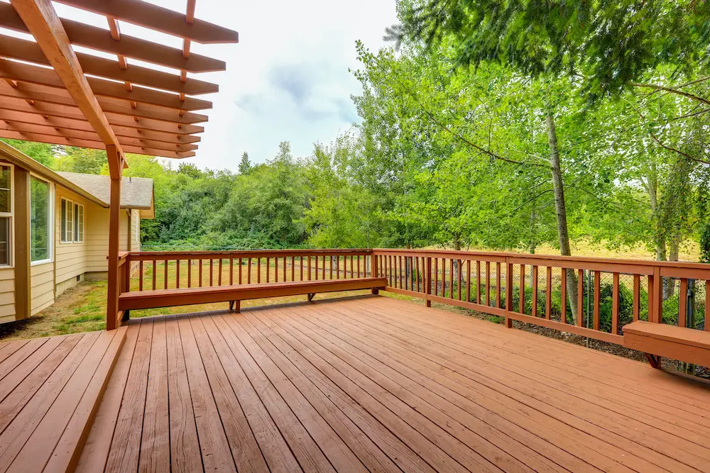 Exterior of horse ranch with empty wooden walkout deck. Northwest, USA