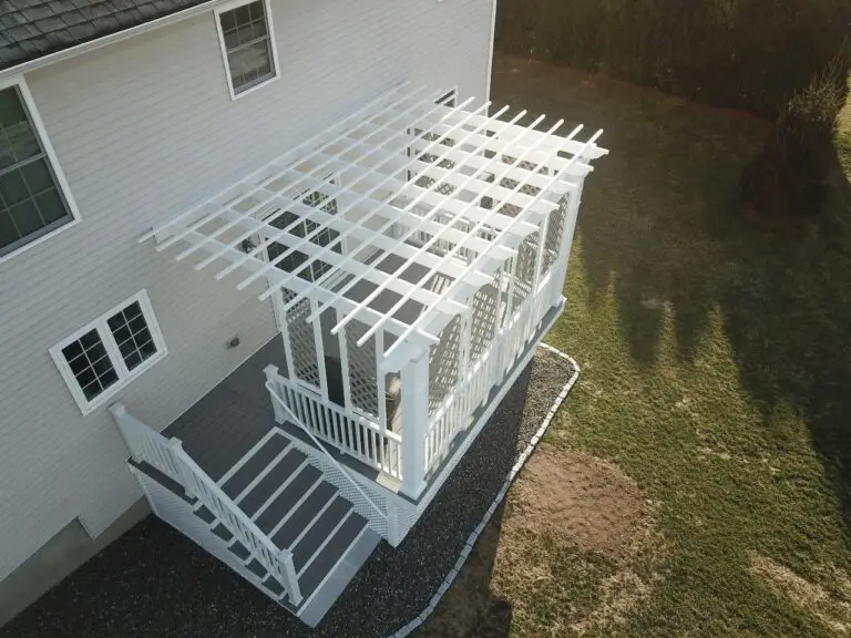 Close-up aerial view of a Trex® Gravel Path Grey deck with a custom white pergola, privacy lattice panels, and enclosed lattice skirting, built by Decks by RTC in Ellington, CT.