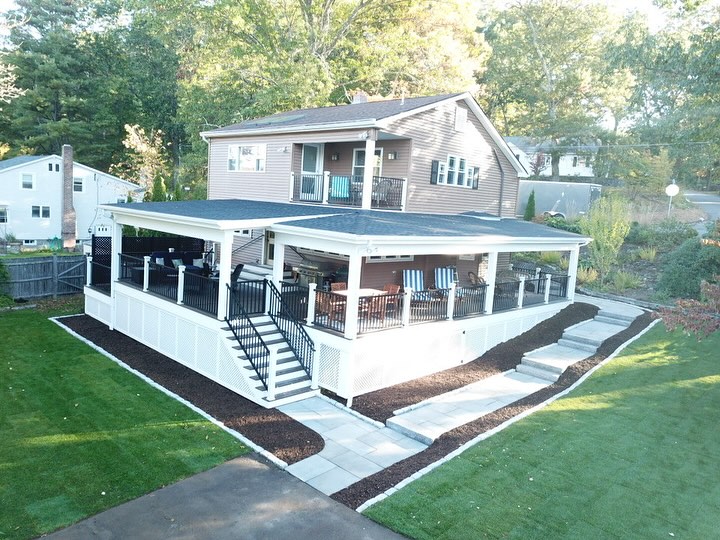 Amazing wrap around composite deck with railings installed by Regan Total Construction