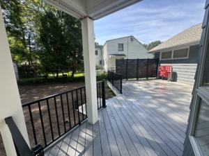 Close angle of deck stairs and landing with black railing system